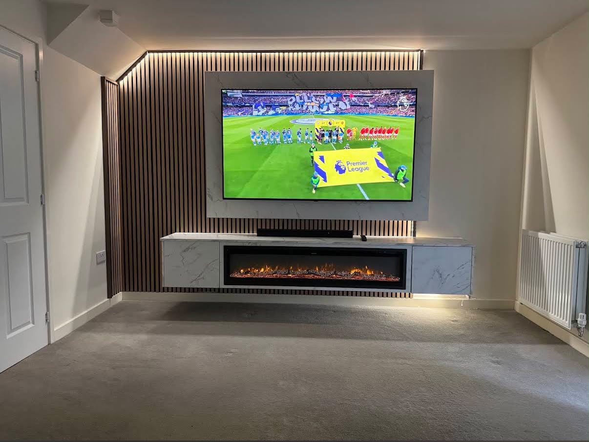 A simple media wall seamlessly integrates a cosy fireplace